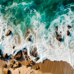 aerial-drone-view-of-sea-waves-crashing-on-the-sandy-beach