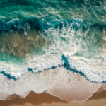 aerial-view-of-a-beautiful-sandy-beach-with-turquoise-ocean-waves