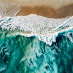 aerial-view-of-the-ocean-waves-breaking-on-a-sandy-beach