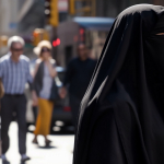 muslim-woman-wearing-a-black-niqab-in-front-of-a-crowd-of-people