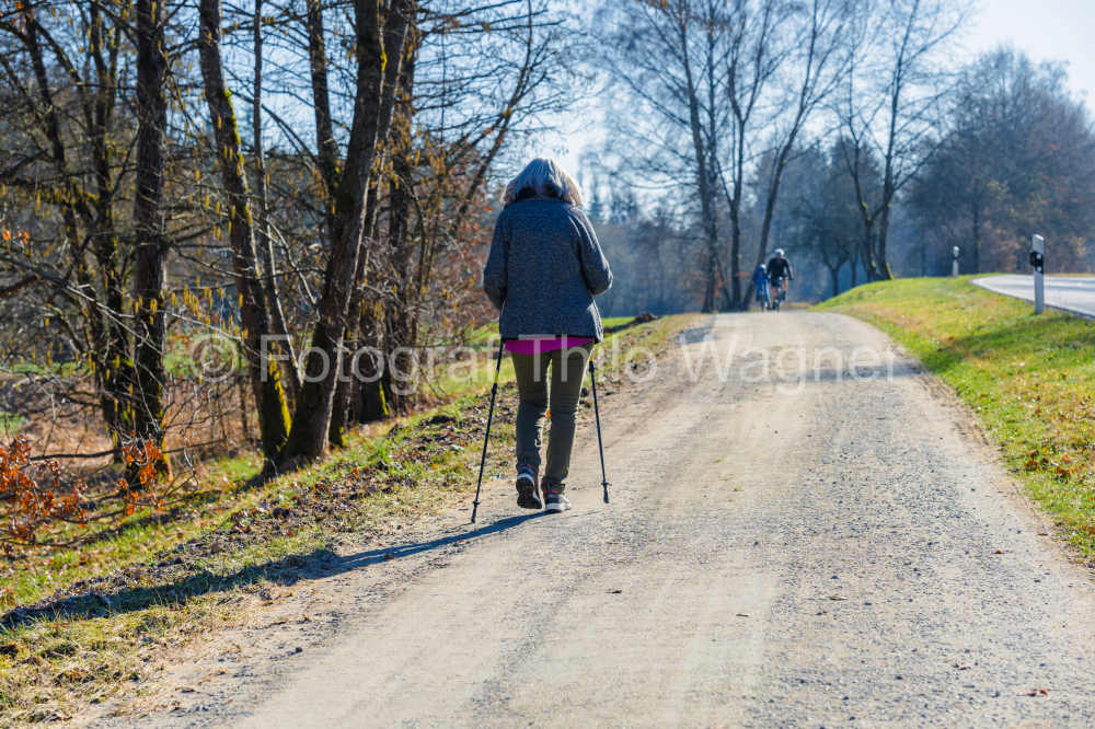 Nordic walking - woman with Nordic walking poles on a country road